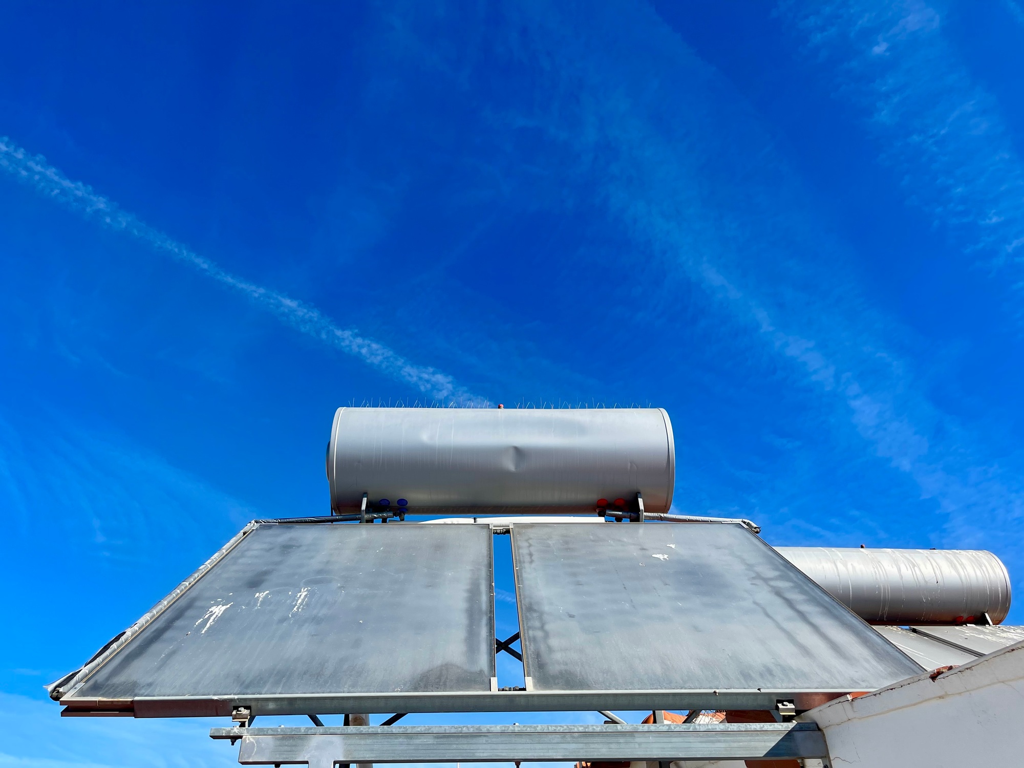 Solar water heater installed on tile roof of house for environmentally